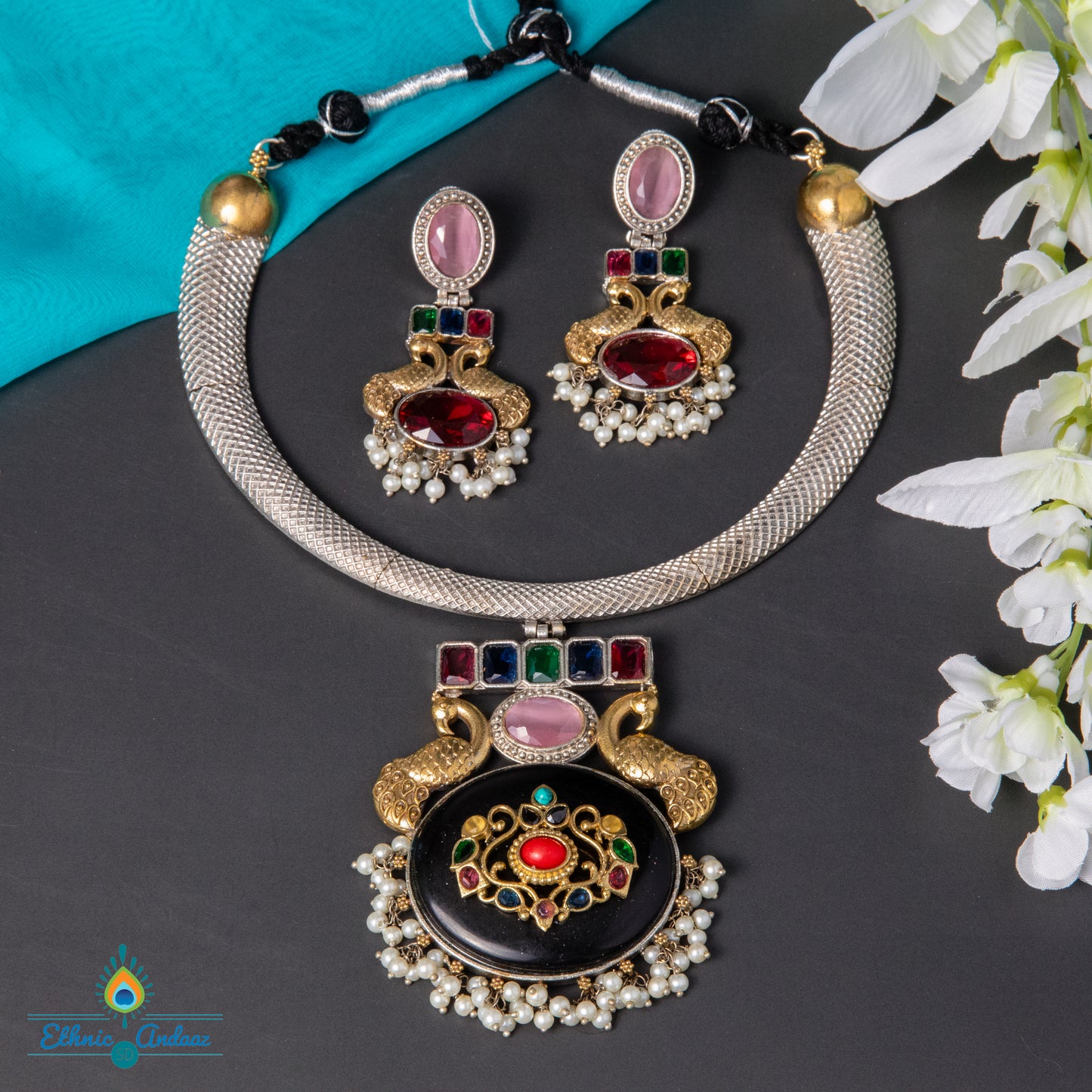 Pihu oxidised jewelry set featuring a statement necklace and matching earrings with colorful stone detailing.
