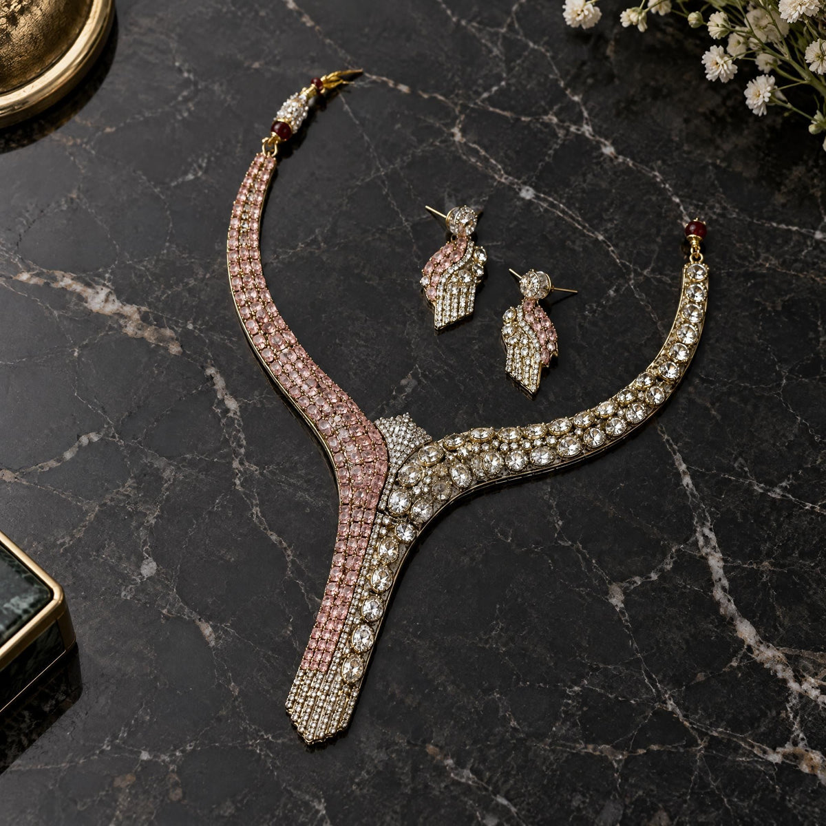 Ruby-inspired cubic zirconia necklace and earrings arranged on a polished dark marble surface.
