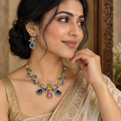 Indian model wearing a multi-colored gemstone necklace and earring set in a three-quarter angle portrait.