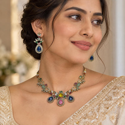 Indian model wearing intricate gold pendant and matching drop earrings featuring traditional artistry.